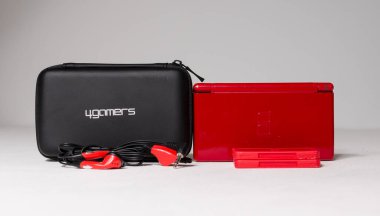 london, uk 05/05/2020A A gloss red nintendo ds lite hand held vintage console bundle, case and games on a white studio background. Retro video gaming handset. nostalgic video gaming clipart