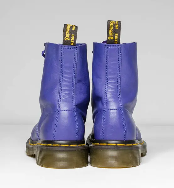 Stock image london, england, 05/05/2019 purple and lilac Dr Martens 1460 white Leather Boots 8 Eye lace hole. fashionable punk historic british made leather boots. dr martens air war with bonding soles. built to last. 