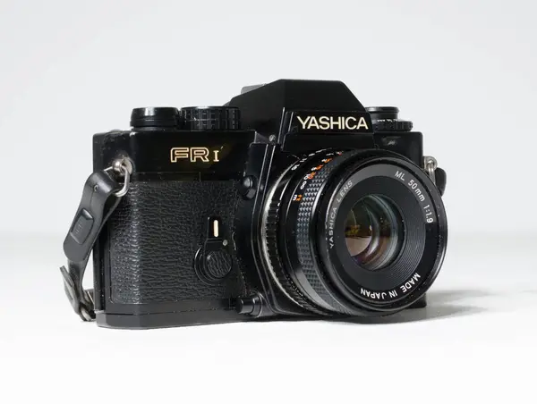 stock image london,uk, 05/05/2019 Black vintage Yashica FR1 SLR Film Camera with 50mm f1.9 Yashica Lens Camera Body isolated on white. Japanese retro vintage classic film camera 