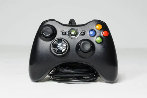 Stock image london, uk 05/05/2020 A wired microsoft  xbox 360 controller on a white studio backdrop. collectable rare home arcade video gaming. joystick and wireless remote technology.