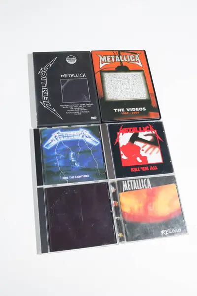 stock image kent, uk 01.01.2023 A collection of death heavy metal Metallica cd collection. Vintage rock music cd bundle collection on a white background.