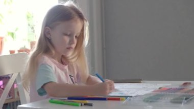 Blonde kid girl school pupil studying online from home watching web art class lesson or listening tutor by video call elearning on pandemic isolation. Children remote education.