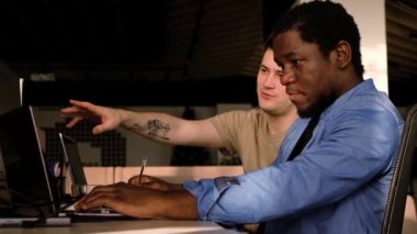 Two programmers working in the office of a software development company. Coding technologies, site design. Successful diverse Teamwork. Cyberspace concept