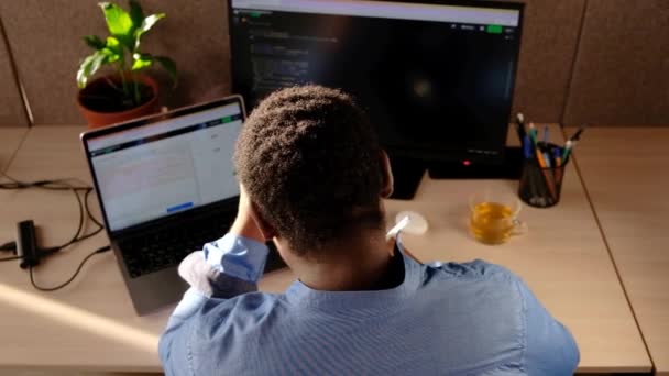 Black Man Writing Lines Code Desktop Two Monitors Laptop Aside — Stockvideo