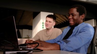 Two programmers working in the office of a software development company. Coding technologies, site design. Successful diverse Teamwork. Cyberspace concept