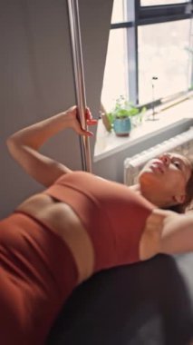 Reformist makinesinde çekirdek ve sırt kasları için pilates yapan kadın azimli ve güçlü vücut odaklı.