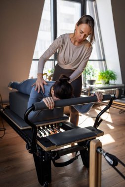 Göğüs ve sırt kasları için Kuğu egzersizi yapan kadın, esneklik, güç ve kararlılıkla kontrol üzerine odaklanıyor.