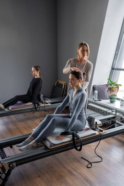 Kadın, ıslah yatağında pilates eğitiyor. Beden eğitimi için pilates stüdyosu makinesi. Formda, sağlıklı ve güçlü özgün bir vücut. Fitness konsepti. Yüksek kalite fotoğraf