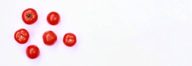 Beyaz arka planda birkaç olgun kırmızı domates, üst manzara. Domatesli pankart ve boş alan