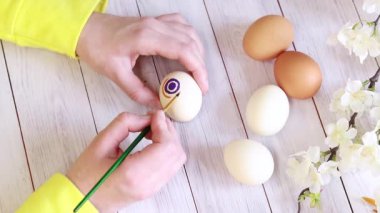 Paint Easter eggs with bright colors, top view. Master class on painting eggs for the holiday. Easter