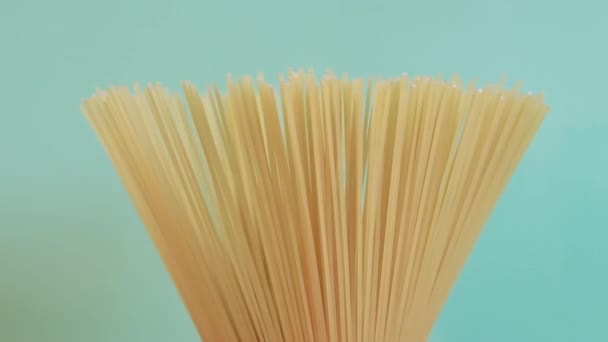 Paquete Espaguetis Sin Cocer Gira Sobre Fondo Azul Vista Lateral — Vídeo de stock
