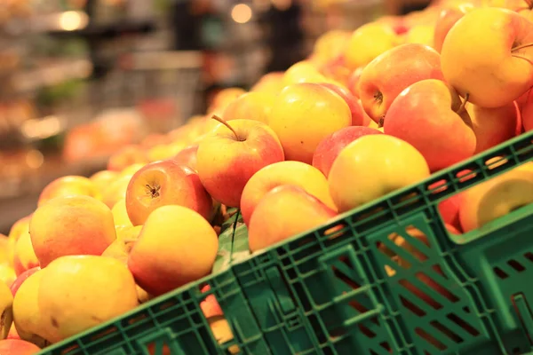 stock image Apples in plastic boxes in a store, close-up. Ripe apples on sale, side view. Sale of fruits