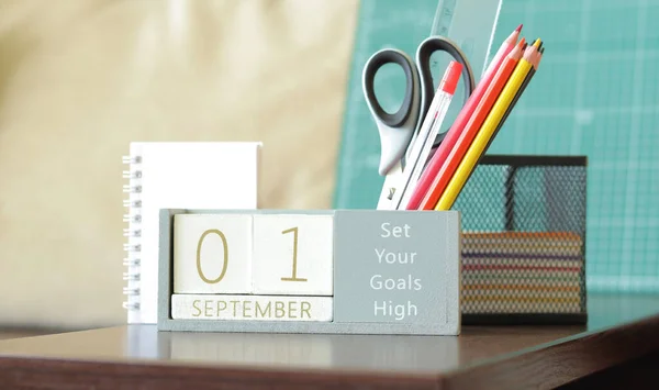 Calendar, September 1st. Back to school. Wooden perpetual block calendar for the table, wooden blocks for displaying the date of the month. Stationery