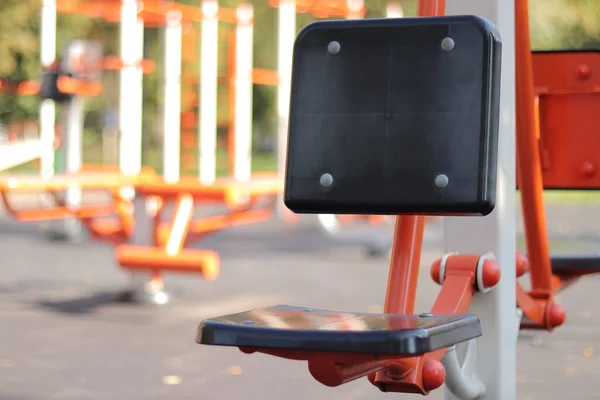 Outdoor sports equipment, sports ground. Outdoor training. Sports concept, selective focus. Exercise machine seat
