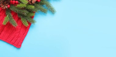 Mutlu yıllar, köknar dalı ve süslemesi olan mavi arka plan, yeni yıl tatili kartı, afiş, üst manzara, boş alan. Uzayı kopyala Noel dalı ve kırmızı eşarp