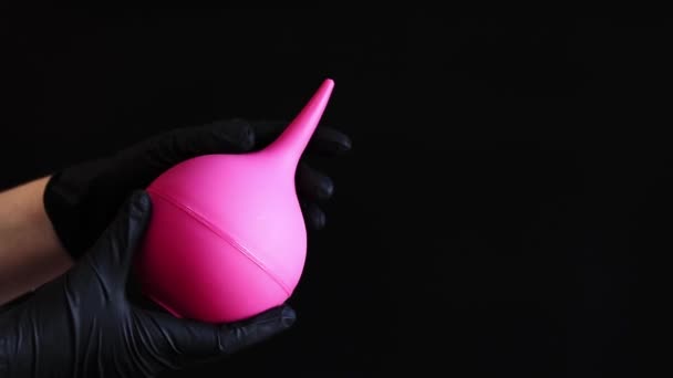 Hand Black Latex Glove Holds Large Pink Enema Dark Background — Stock Video