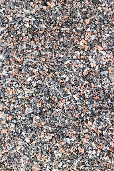 Crushed stone, close-up, top view. Fine granite crushed stone. Construction materials, background. Gravel