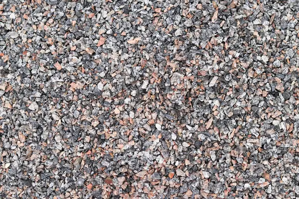 Crushed stone, close-up, top view. Fine granite crushed stone. Construction materials, background. Gravel