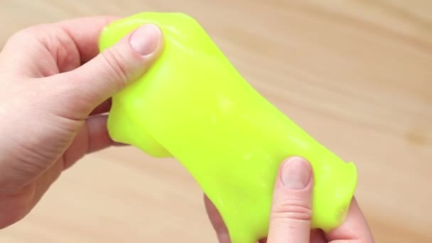 Girl Kneads Yellow Slime Background Table Woman Hands Stretch Bright — Stock Video