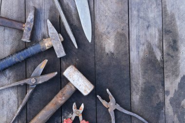 Tahta bir yüzey üzerinde eski iş aletleri, üst manzara. Çekiç, balyoz, teneke makas, kerpeten ve bıçak. El aleti. İnşaat Günü ya da Babalar Günü. İnşaat ve yenileme konsepti