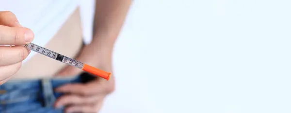 İnsülin şırıngası. Elinde şırınga olan bir kadın kendine insülin enjekte etmek üzere. Diyabet tedavisi. Tıp ve sağlık konsepti. Kendine evde insülin enjekte et. Sağlık Hizmetleri