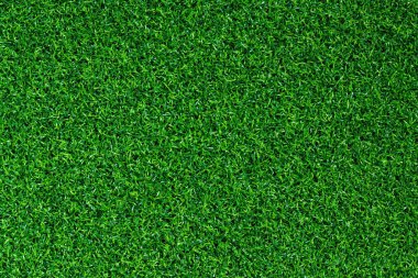 Yapay yeşil çimen paspası, üst manzara. Doku. Suni çim, yapay liflerden yapılmış yüzey. Düz yeşil çimen dokusu. Kısa yapay golf sahası