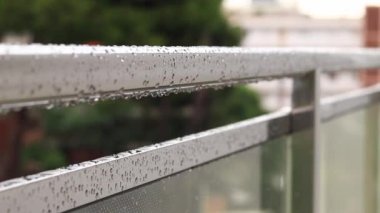 Yağmurda balkon korkulukları, seçici odaklanma. Balkon korkuluklarında yağmur damlaları, ıslak balkon. Balkon korkuluklarına düşen yağmur damlaları. Su damlası