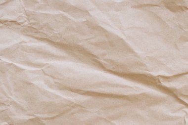 Buruşuk el işi kâğıdı geçmişi. Buruşuk el işi kağıt dokusu ya da kağıt arka plan. Kopya alanı olan bir arkaplan. Üst Manzara. Mesaj için yer var. Buruşuk kahverengi kağıt dokusunun yakın plan görüntüsü