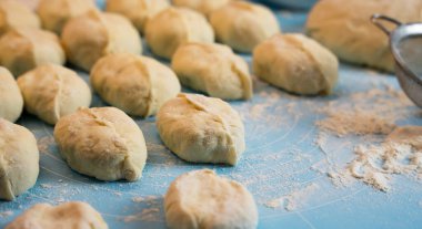 Stuffed pies on the table. The process of cooking pies at home. Close-up. Selective focus.