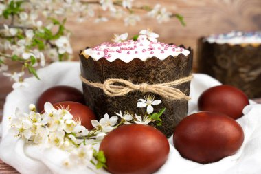 Colored eggs and Easter cake on the table. Close-up. Selective focus.