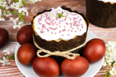 Easter cake and colored eggs on the festive table. Christian traditions. Close-up. Selective focus.