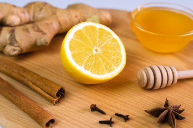 A lemon, honey, ginger and spices for a delicious vitamin and healthy drink. Alternative medicine. Close-up. Selective focus.