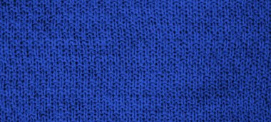 Mavi renkte örülmüş yün kumaş dokusu. Üst Manzara. Yakın plan. Pankart. Seçici odak.