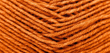 The texture of the wool is dyed orange. Abstract background. Close-up. clipart