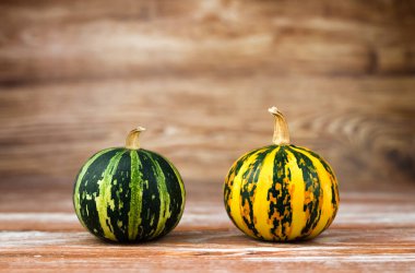 Ahşap bir arka planda iki balkabağı. Yakın plan. Boşluğu kopyala.