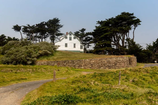 stock image Point Reyes, California, USA. May 1, 2021. Beginning of Chimney Rock trail featuring a historic white house inside Point Reyes National Seashore on a blue-sky day, and cypress trees