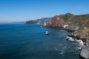 Rock formations at the Marin Headlands, Golden Gate North, California, USA, recreation area on a sunny day with blue sky copy-space, horizon over water, and plenty of space for copy