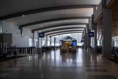 Sacramento, 5 Nisan 2024. Yolcular, neredeyse boş olan Sacramento Uluslararası Havaalanı 'nda, çiftlikten çatala ekspres kabininin yer aldığı uçuşlarını bekliyorlar.