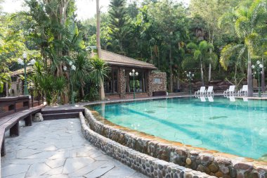 Phu Pha Nam Resort & Spa, Loei, Thailand April 8, 2017.The swimming pool of the resort. There is a tree surrounded and beautiful nature. Ideal for relaxation. clipart