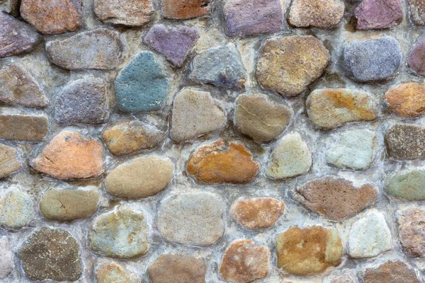Small rocks placed  in order to beautiful and fastened by cement. Use a flooring and walls, decorative home and garden.