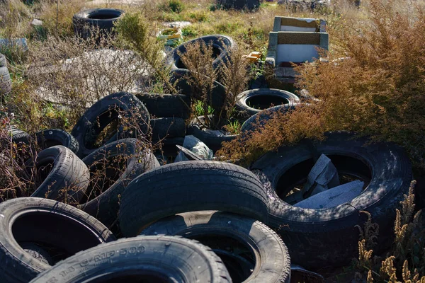 Closeup used truck tires. Old tyres waste for recycle or for landfill. Black rubber tire of truck. Pile of used tires at recycling yard. Material for landfill. Recycled tires. disposal waste tires
