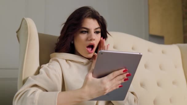 Charming Millennial Teen Sitting Couch Living Room Staring Amazement Digital — Stock videók
