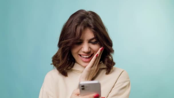 Astonishing Charming Attractive Adolescent Holding Smartphone Looking Happy Satisfied Her — Wideo stockowe