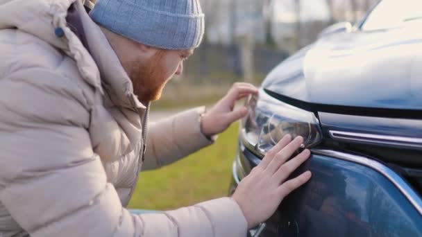 Handsome Bearded Man Examines His Headlights His Car Watches Carefully — Stock video