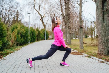 Woman performs stretching before jogging. High quality photo