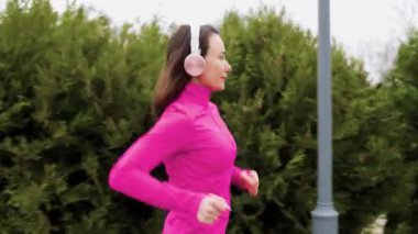 A solo female jogger running outside in the early morning light, training hard for her next marathon and pushing herself to new limits