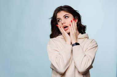Photo portrait of offended girl with open mouth isolated on pastel blue colored background. High quality photo