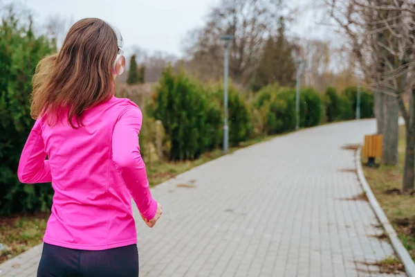 Una Atleta Corriendo Con Smartphone Auriculares Manteniéndose Motivada Energizada Mientras — Foto de Stock