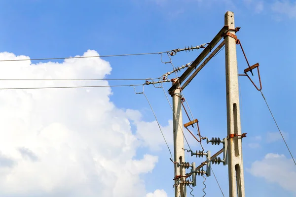 Overhead electric power lines with cable and Electric Transformer setup between farm land Indian rural area. electrical transformer utility pole under the blue sky background power Infrastructure