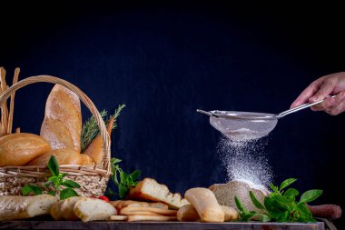 Tahta bir masada, ekmeğin üzerinde un ellerken...